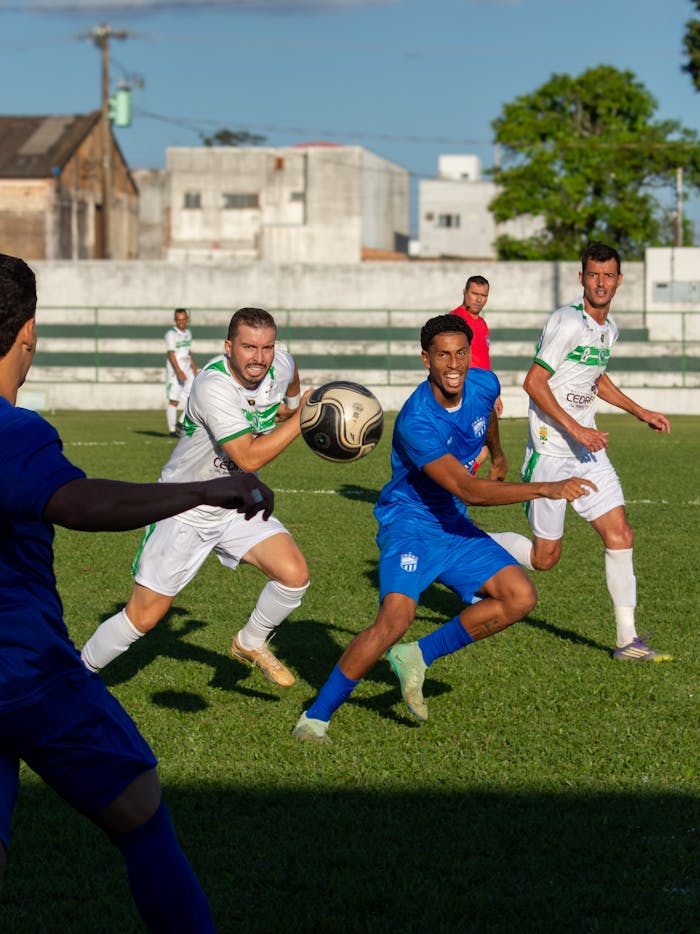 Action-packed soccer match with players competing fiercely on a green field under the sun.